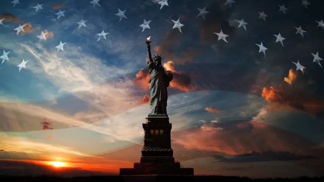 statue of liberty and american flag